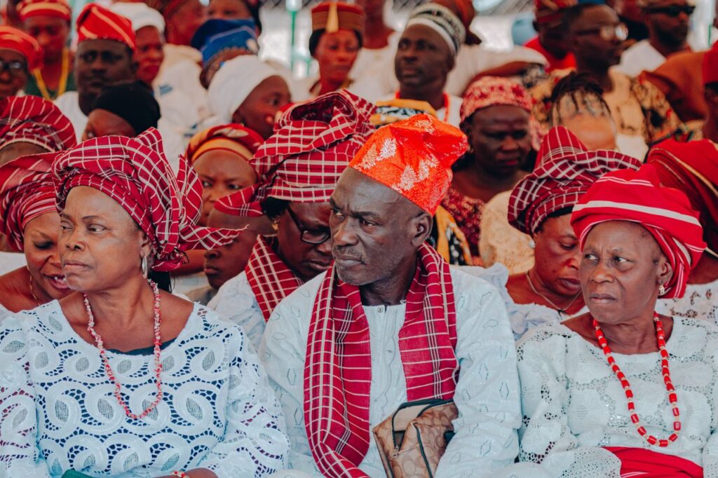 A vibrant display of cultural attire at a Nigerian gathering showcasing traditional clothing and headwear.